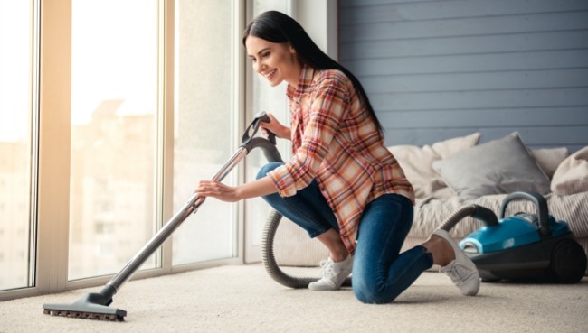 Lady cleaning carpet floor | Rocky Mountain Flooring